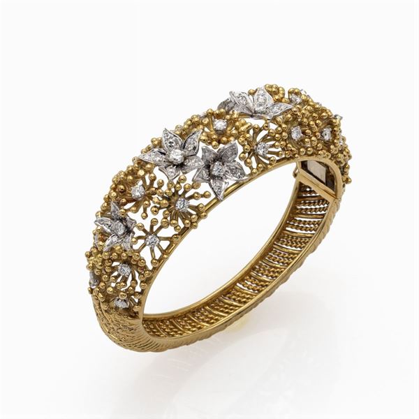 Bracciale a manetta in oro giallo e bianco 18kt  e diamanti