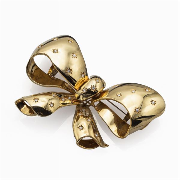 Spilla fiocco in oro giallo 18kt e diamanti