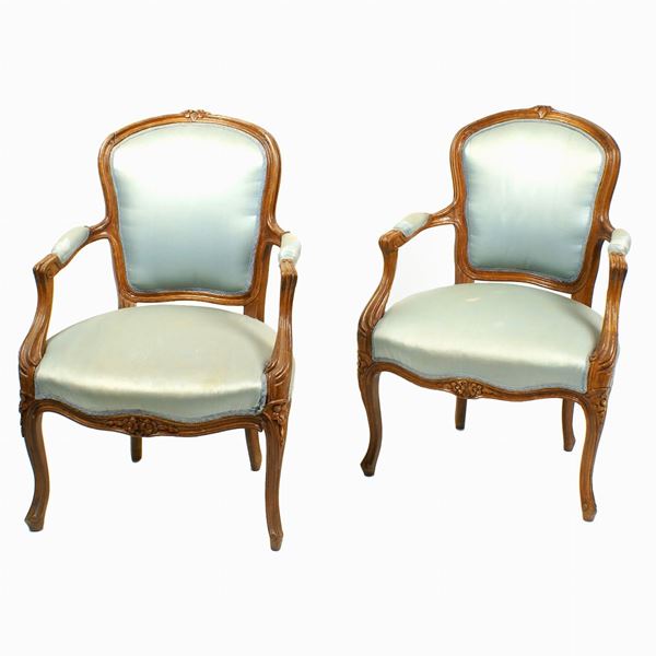 A pair of beech wood armchairs