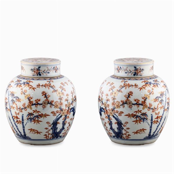 Pair of  polychrome porcelain vases with lid