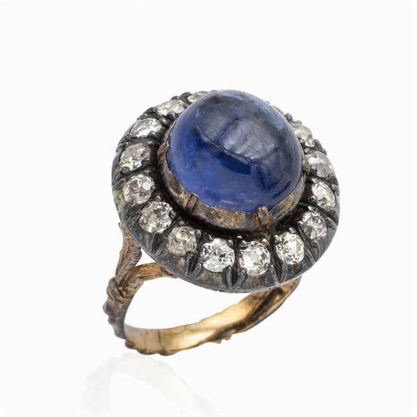 Anello in oro giallo e argento con zaffiro naturale e rose coroné
