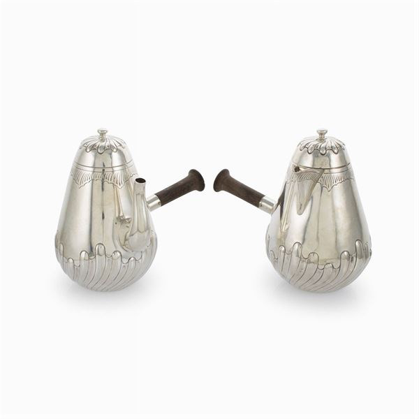 A coffee pot and a silver milk jug