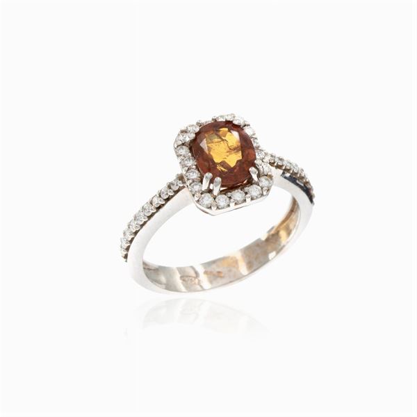 18kt white gold ring with natural orange sapphire