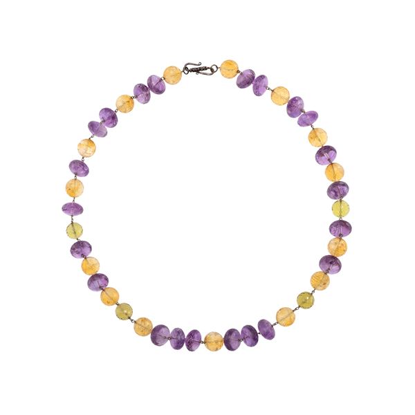 Necklace with a strand of amethysts alternating with citrine quartz and smoky quartz