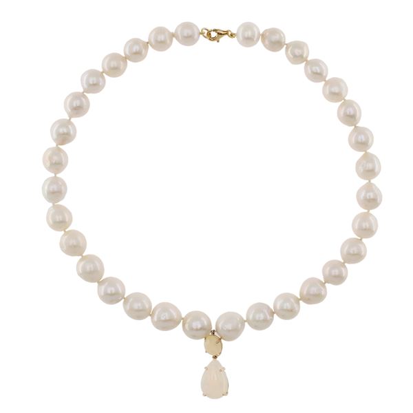 Single strand of baroque pearl necklace with pear cut harlequin opal pendant