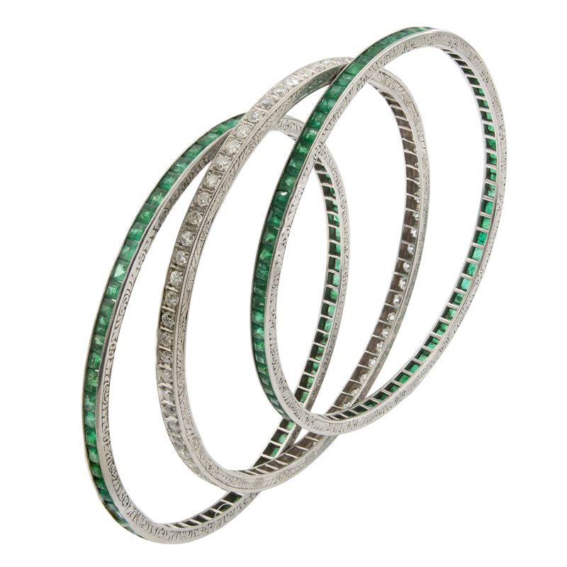 Tre bracciali a manetta in platino smeraldi e diamanti