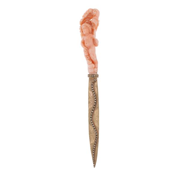Paper cutter in pink coral carved to depict a winged putt
