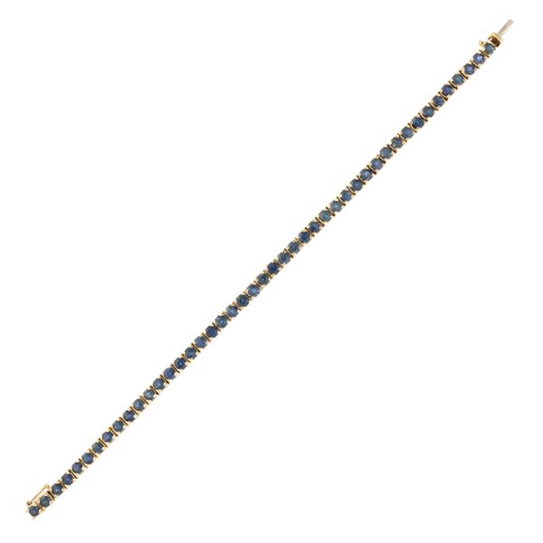 Bracciale tennis in oro giallo 18kt e zaffiri tondi