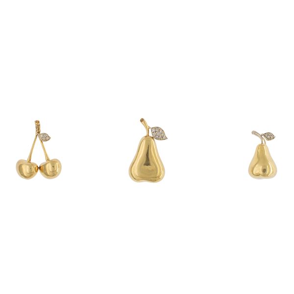 Three 18kt yellow and white gold and diamonds fruit pendants