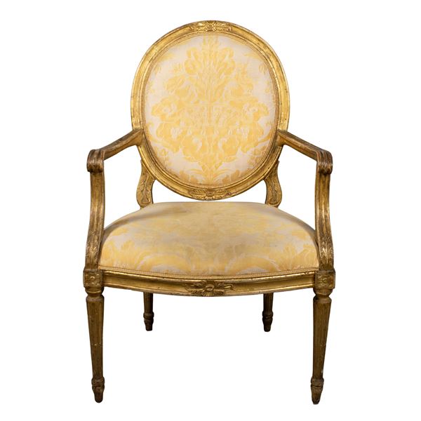 Golden and carved wooden armchair