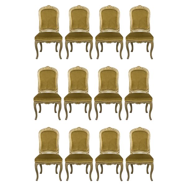 Twelve carved, lacquered and golden wood chairs