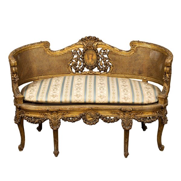 Golden and carved wooden sofa