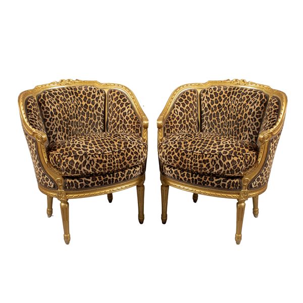 Pair of golden and carved wooden armchairs