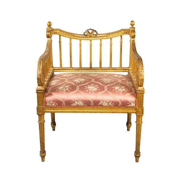 Golden and carved wooden armchair