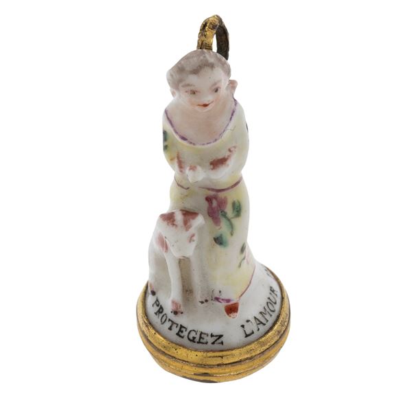 An antique 9kt yellow gold engraved corniola and polychrome porcelain pendant seal