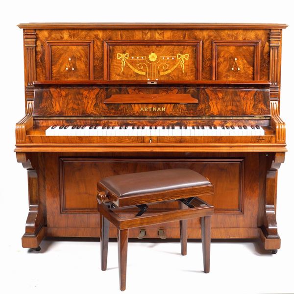 An Artman upright walnut piano