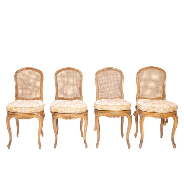 Four wooden chairs carved with floral motifs