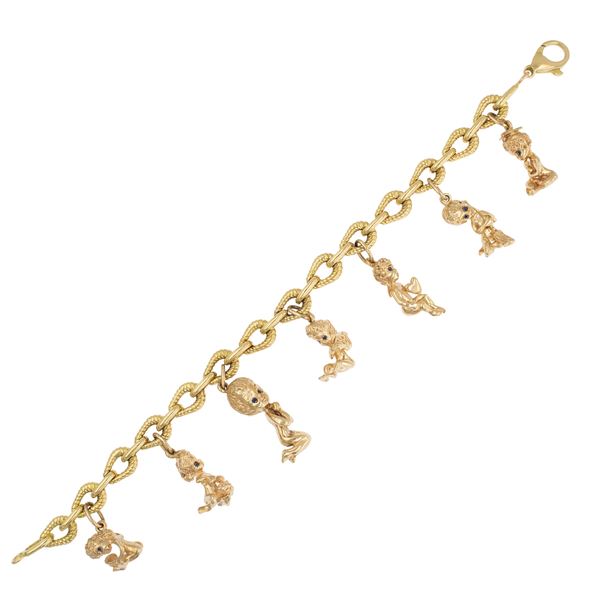 Bracciale con sette putti pendenti in oro a due colori 18kt