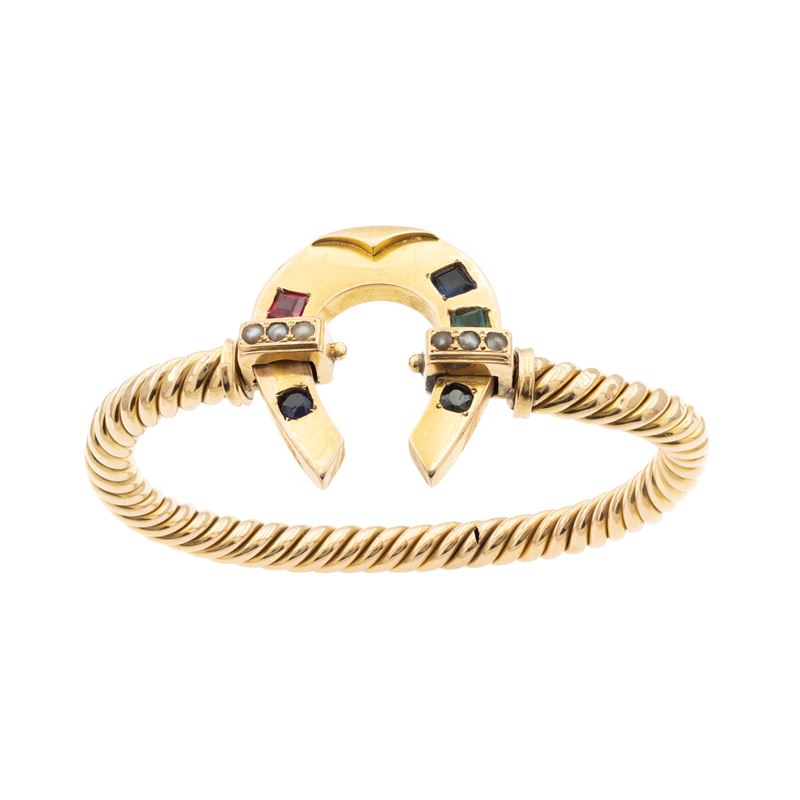 Bracciale a manetta in oro giallo 18kt con ferro di cavallo