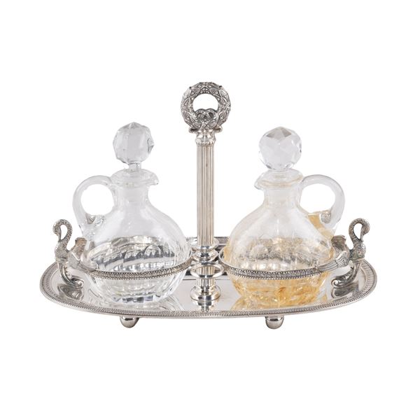 Silver cruet stand with two clear glass bottles