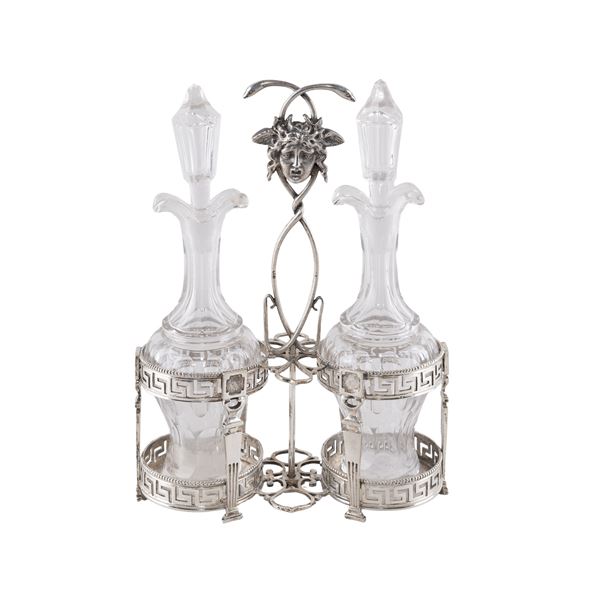 Silver cruet with two cut glass cruets