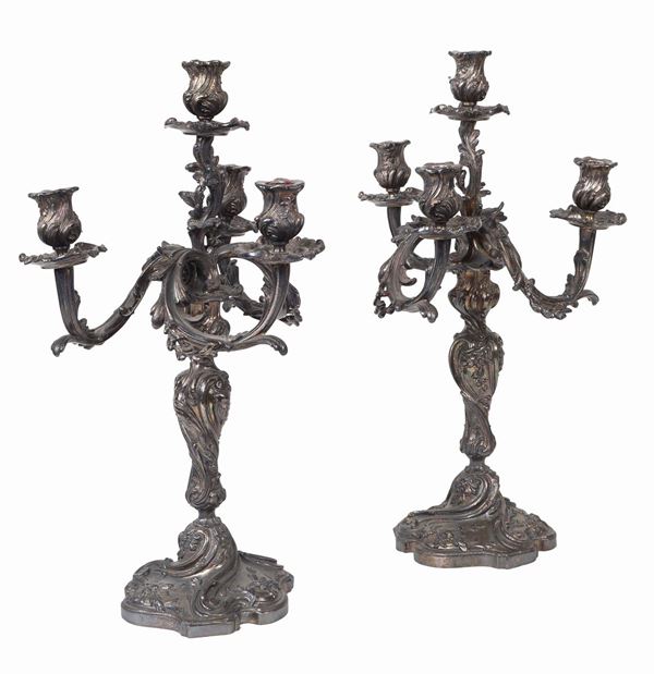 A pair of silvered metal four-branch candelabra